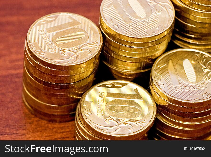 Golden Coins On A Wooden Table Close Up