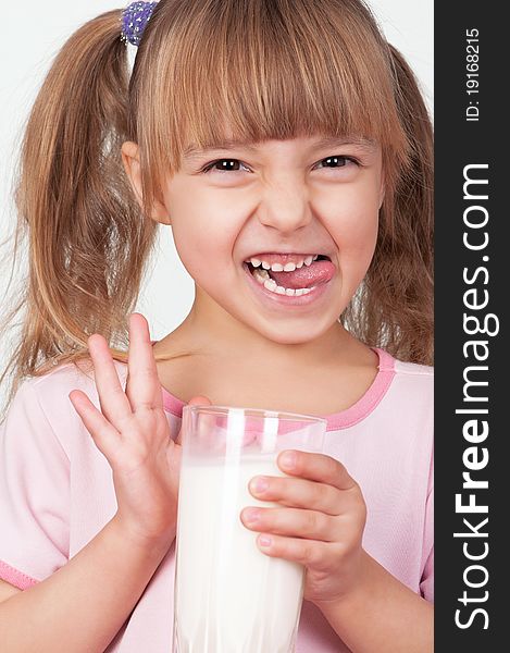 Cute little girl with glass of milk on light background. Cute little girl with glass of milk on light background