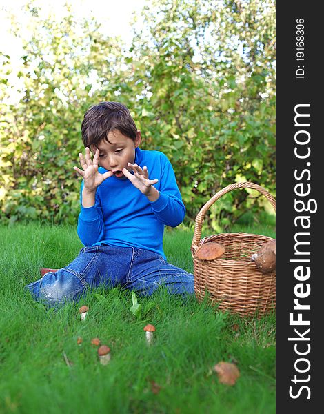 Little boy with mushrooms outdoors