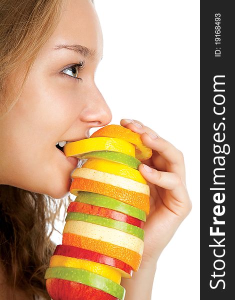 Portrait of happy young woman holding mixed fruits over white background