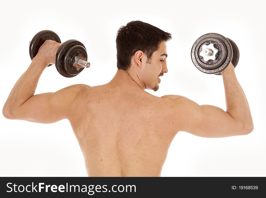 A man is working out with some weights.  View of his back. A man is working out with some weights.  View of his back.