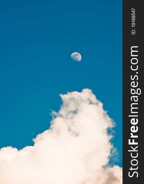 The moon and white clouds on blue sky