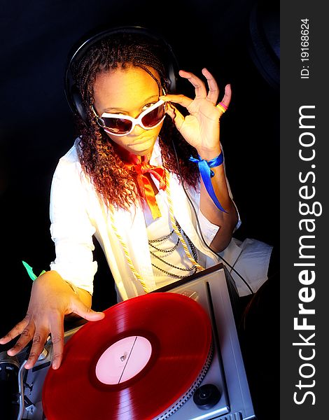 Cool afro american DJ in action under yellow light