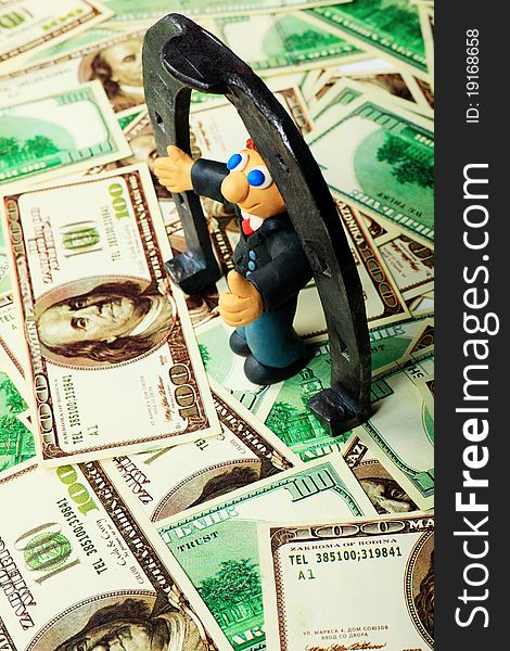 Shot of a plasticine businessman in a suit. Over money background. Shot of a plasticine businessman in a suit. Over money background.