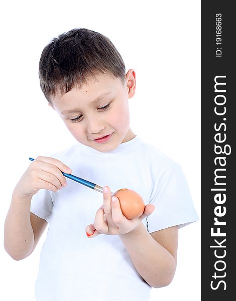 Little boy painting easter egg isolated on white