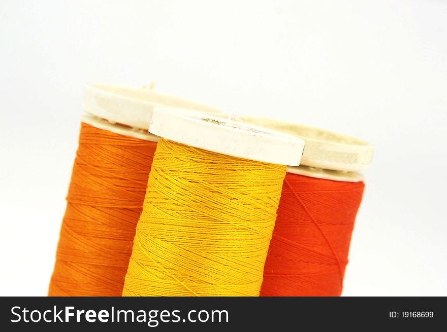 Group of three colourful spools, yellow,orange and red. Group of three colourful spools, yellow,orange and red