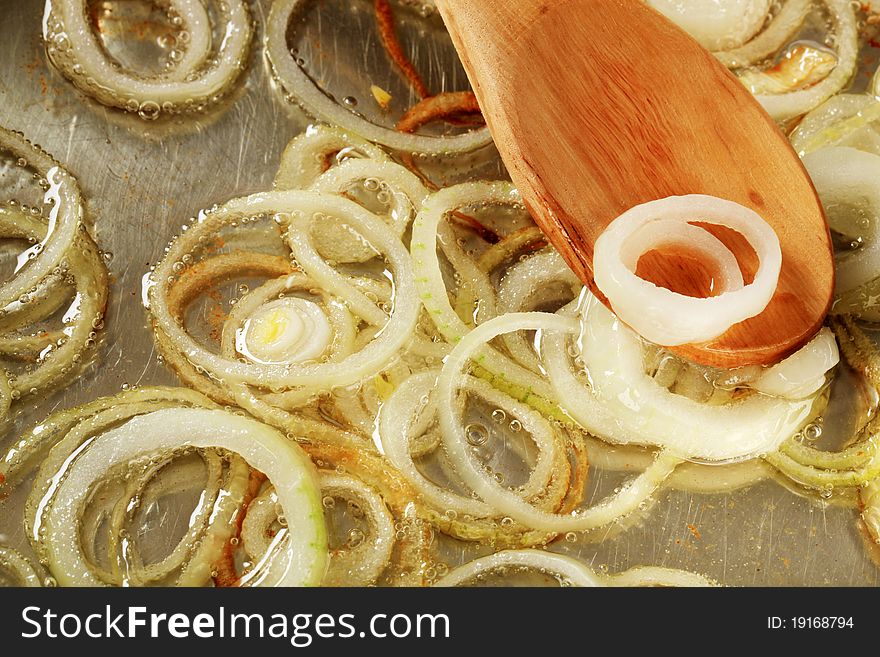 Frying onion rings in a pan - detail