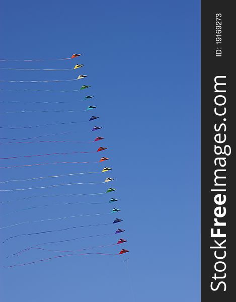 Colorful kites against a vivid blue sky