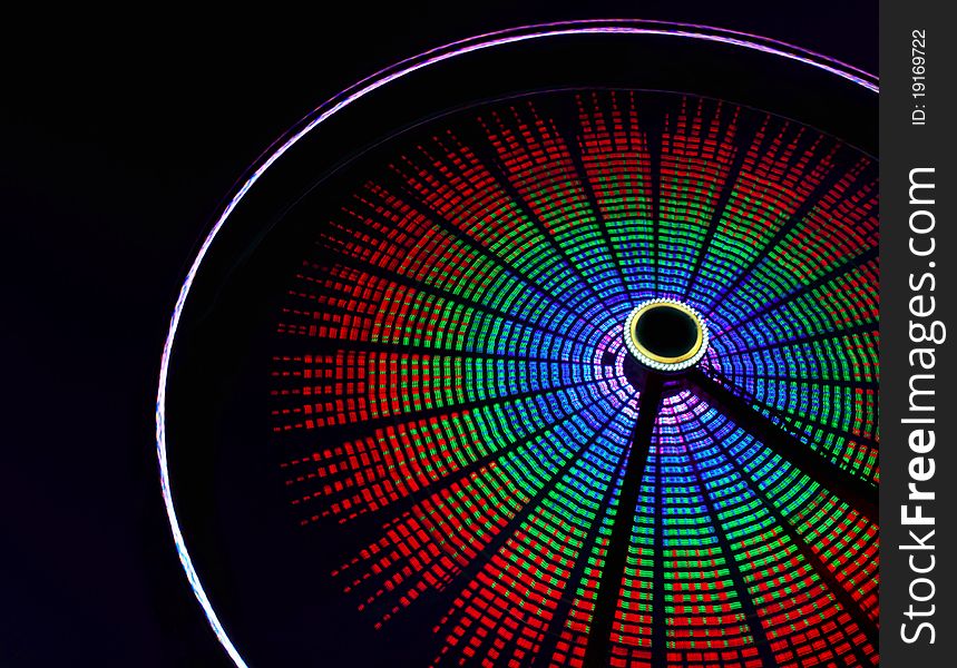 Spinning ferris wheel against the night sky.