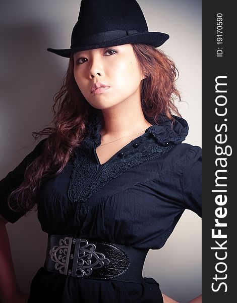 Asian young woman in black fashion shoot.