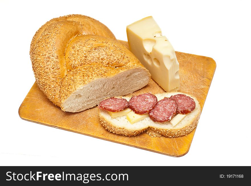 Sausage cheese and bread on a wooden board