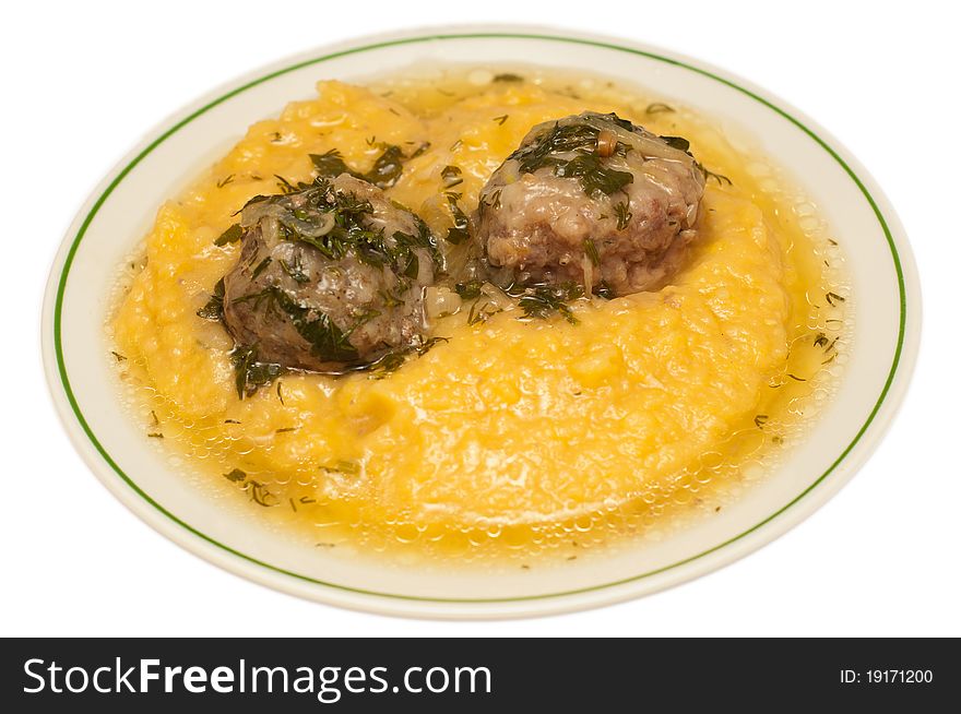 Mashed peas with meatballs against white background