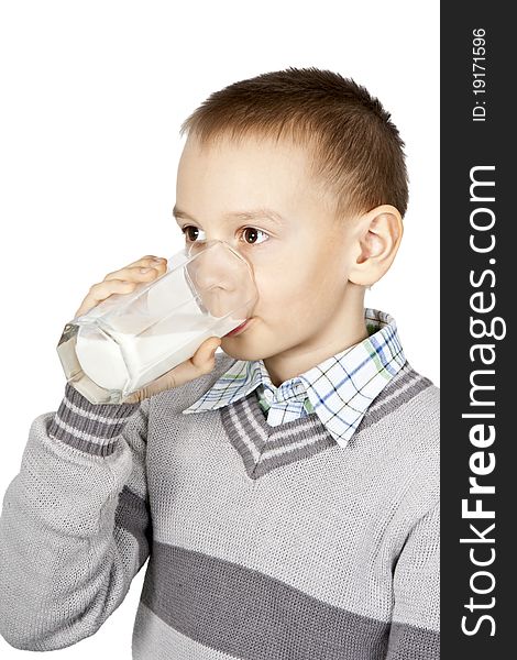 Boy drinking milk from a glass beaker on a white background. Boy drinking milk from a glass beaker on a white background.