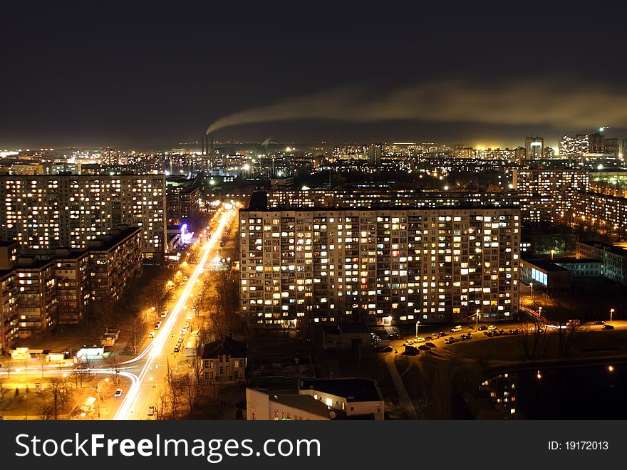 Landscape of a night city with fires and a smoke from a pipe against the sky. Landscape of a night city with fires and a smoke from a pipe against the sky