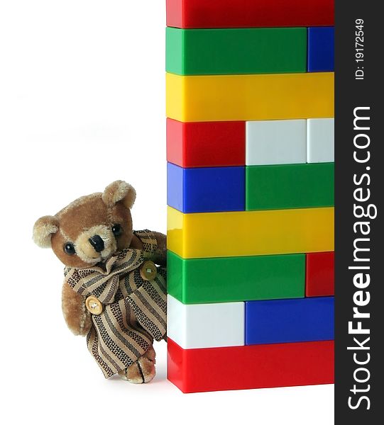 LittleTeddy Bear and stack of plastic motley bricks