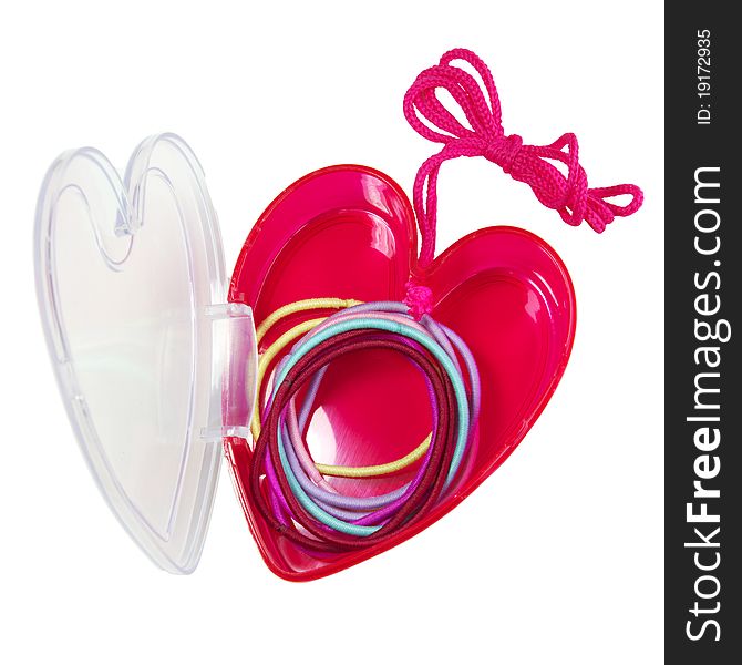 Colorful hair bands in a plastic, heart-shaped case.