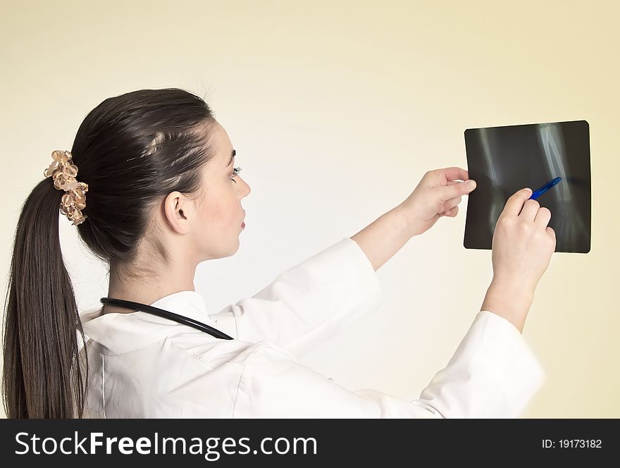 Young and nice doctor watching a patient x-ray