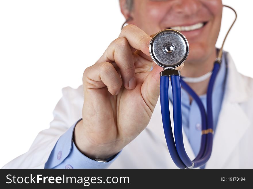 Close-up of a stethoscope,in background the smiling doctor.Isolated on white background. Close-up of a stethoscope,in background the smiling doctor.Isolated on white background.