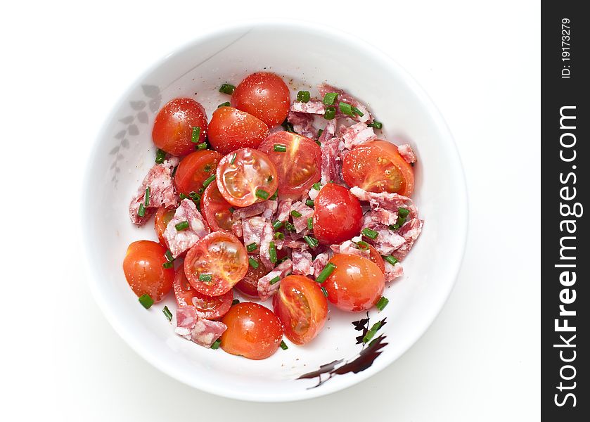 Mixed salad with cherry tomatoes and salami in a bowl. Mixed salad with cherry tomatoes and salami in a bowl