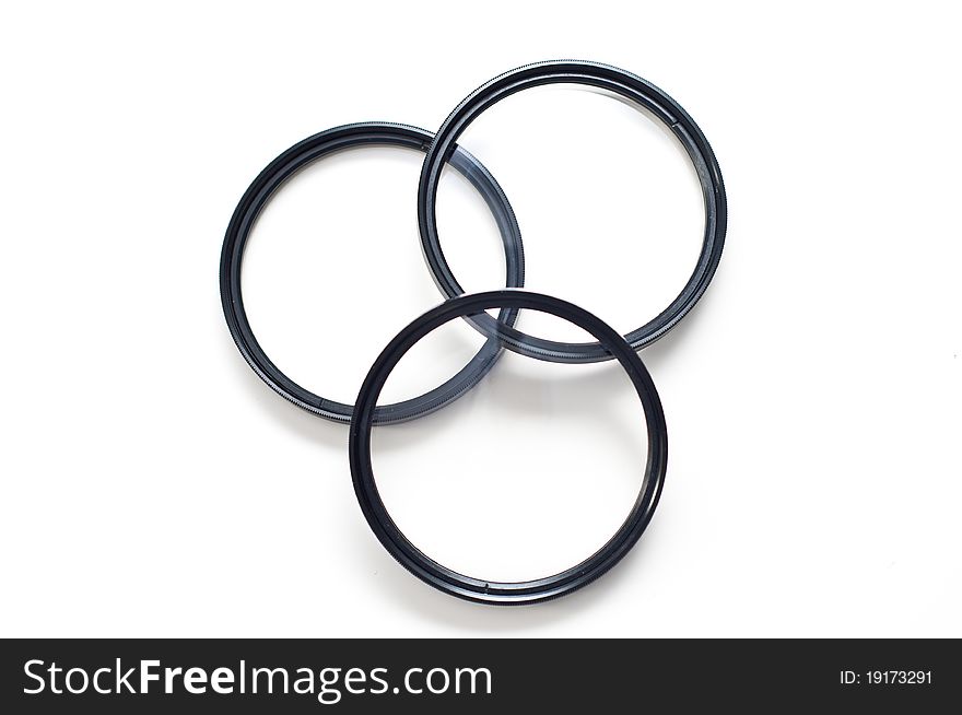 Set of three screw-in photographic lenses on white