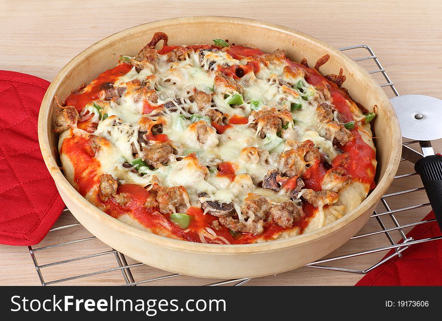 Sausage and mushroom pizza in a deep dish. Sausage and mushroom pizza in a deep dish