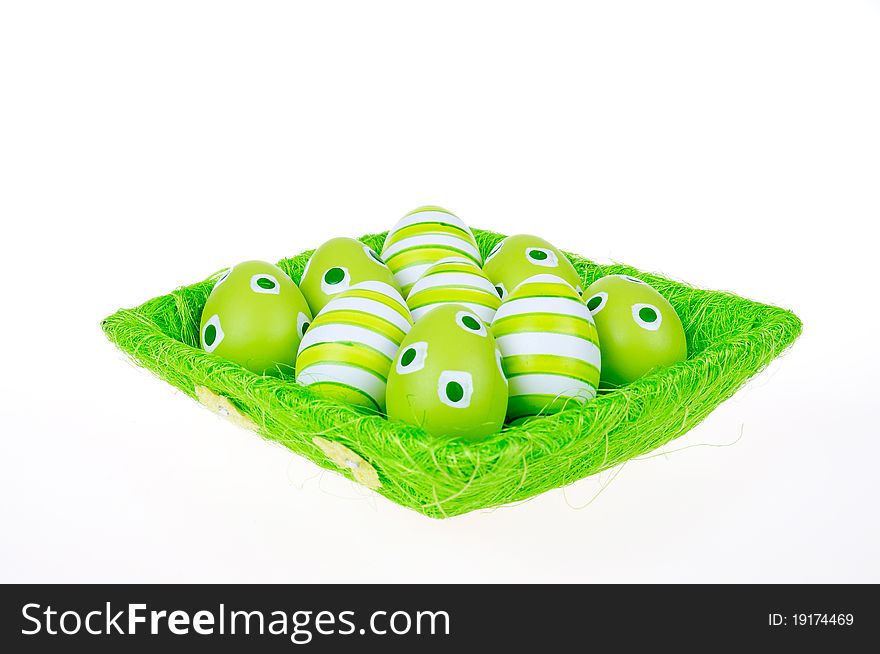 Eggs in the green Easter basket. Painted eggs