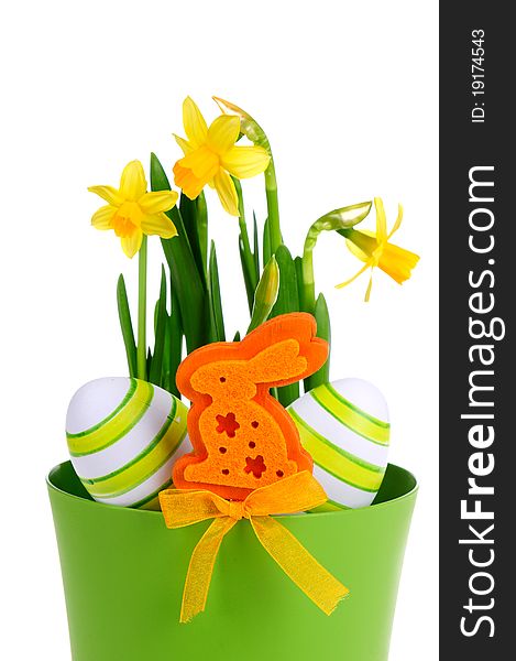 Painted easter egg and yellow daffodil on the green background.