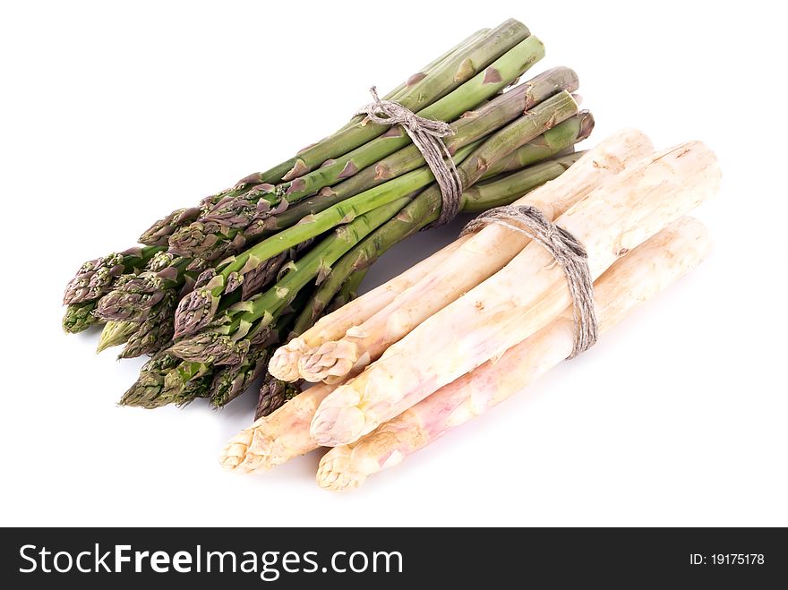 A bunch of green and white asparagus in front of white background