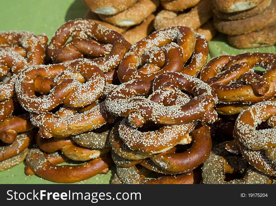 Heap of freshly baked pretzels with sesame seeds