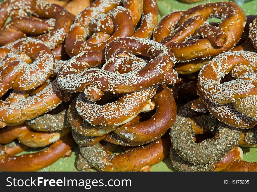 Heap of freshly baked pretzels with sesame seeds