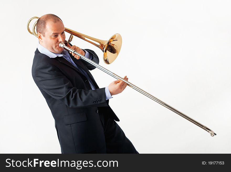 Portrait of a young man playing his trombone. Portrait of a young man playing his trombone.