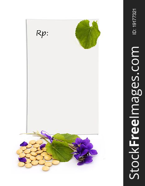 Herbal pills and flowers on a white background