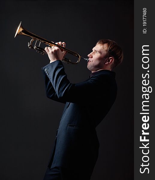 Portrait of a young man playing his Trumpet. Portrait of a young man playing his Trumpet