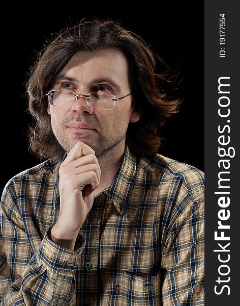 Portrait of handsome man with long hair. Isolated on black background.