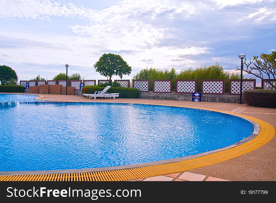 Wide Swimming pool in curve style with blue sky. Wide Swimming pool in curve style with blue sky