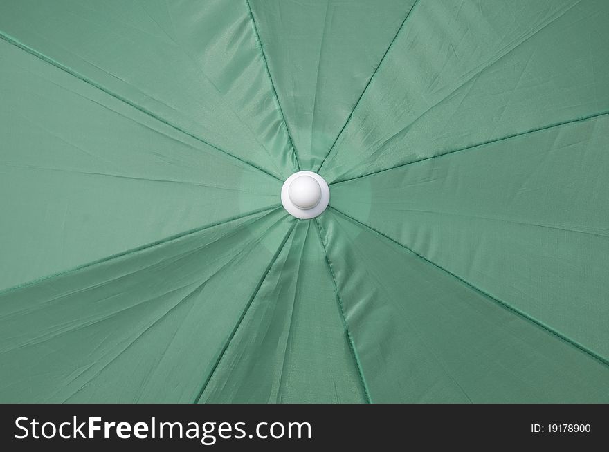 Green beach umbrella top background