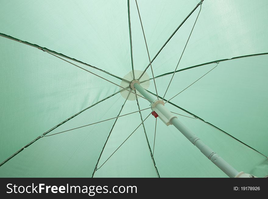 Green beach umbrella inside frame background