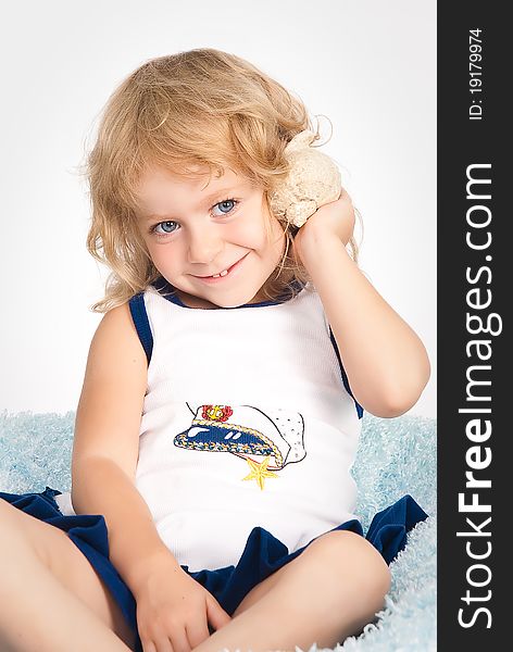 Isolated portrait of pretty girl with seashell in studio