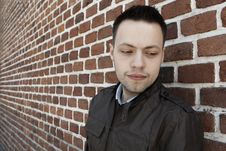 Young Man In Fron Of The Brick Wall Royalty Free Stock Photography Young Man In Fron Of The Brick Wall Royalty Free Stock Photography