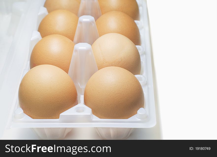 Eggs in plastic egg box from supermarket on white background. Eggs in plastic egg box from supermarket on white background.