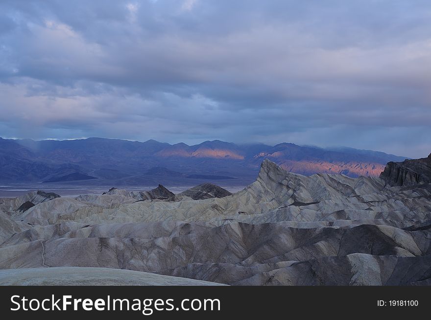 Breaking dawn over the mountains lighting up the valley in a single ribbon of light. Breaking dawn over the mountains lighting up the valley in a single ribbon of light