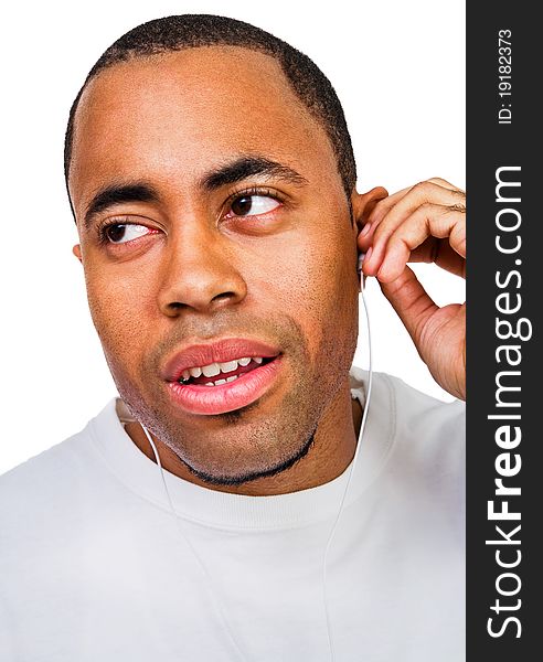 Man listening to music on a MP3 player isolated over white. Man listening to music on a MP3 player isolated over white