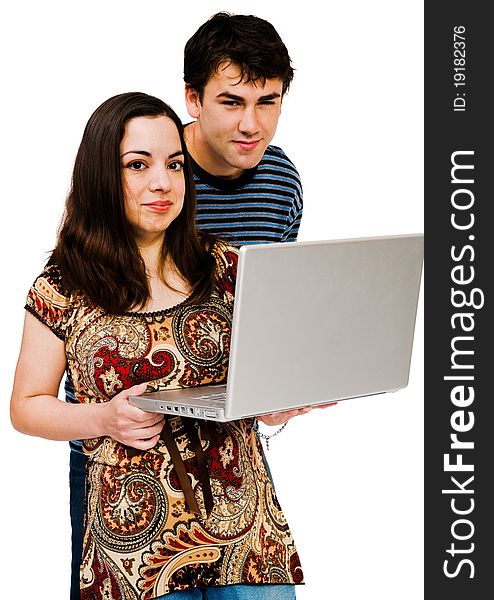 Couple using a laptop and smiling isolated over white