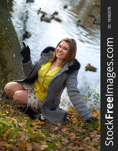 Young beautyful girl sitting on grass on a sunny day in a park. Young beautyful girl sitting on grass on a sunny day in a park