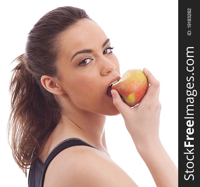 A young female eating an apple on isolated white background. A young female eating an apple on isolated white background