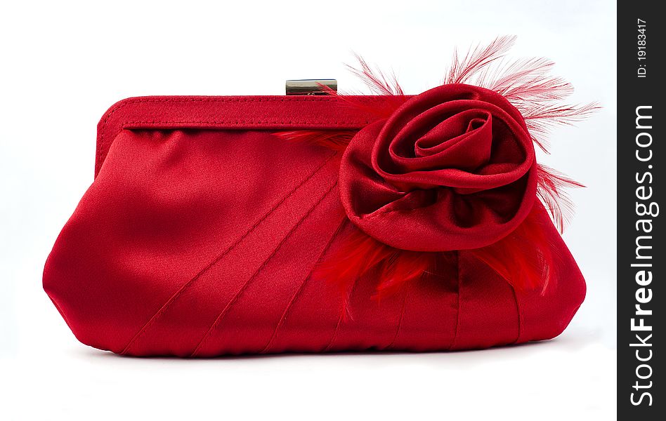 Female red handbag with a flower isolated on seamless white background