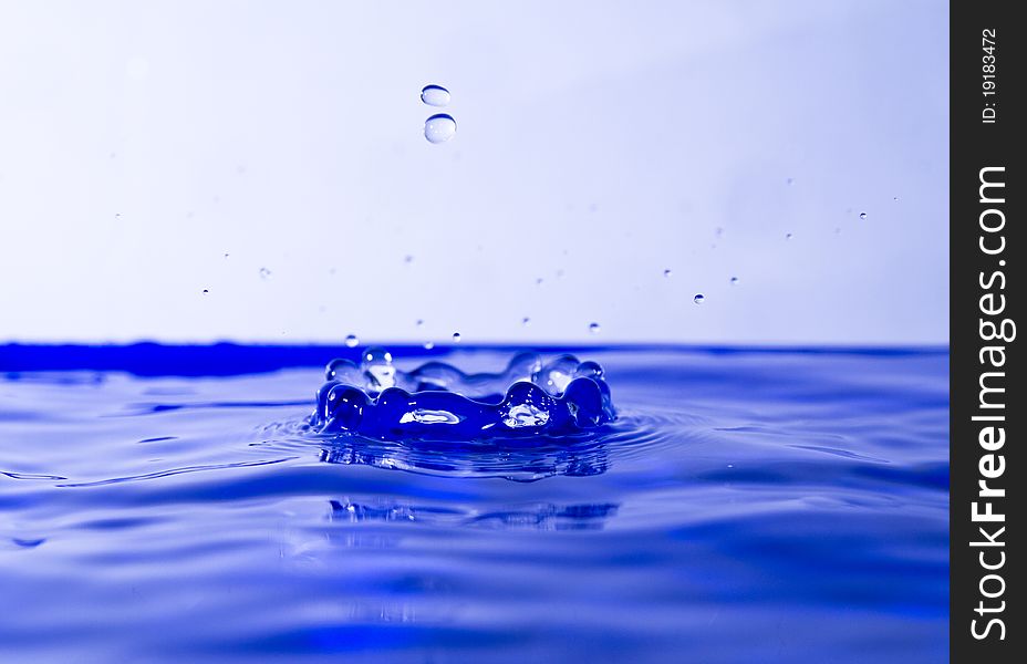 Two tiny drops of water seen going into a crown-in  the making. Two tiny drops of water seen going into a crown-in  the making