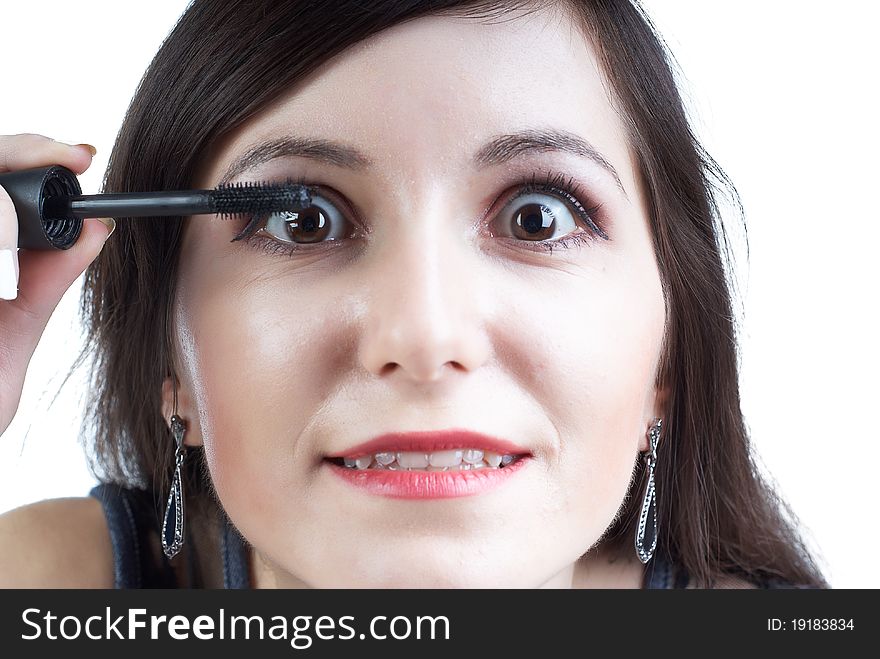 Beautiful girl with dark hair does a morning make-up