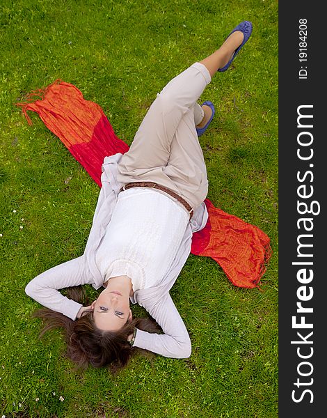 Brunette Lying In The Grass