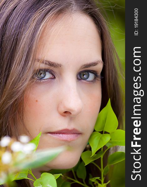 Young attractive woman portraited in the greenery of the city park. Young attractive woman portraited in the greenery of the city park.